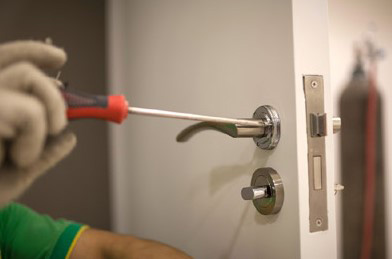 Locksmith Working On Door Handle